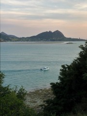 We're thinking of Jim and Diane as this little boat anchors for sunset in front of our deck